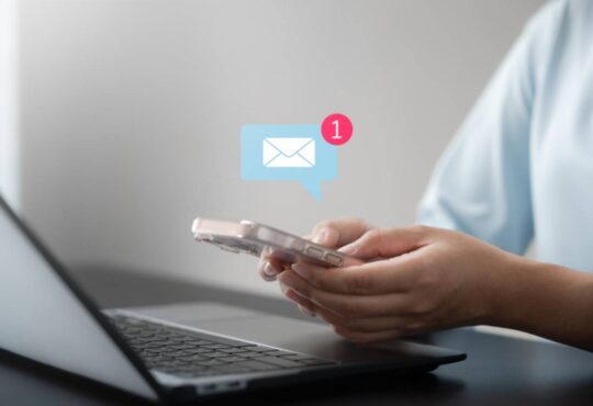 Business woman using smartphone with notifications.