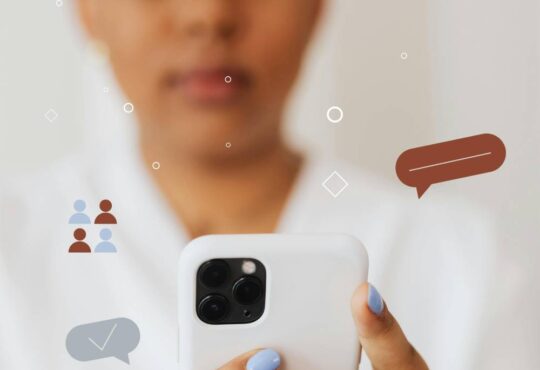 Close up of woman holding a phone receiving multiple notifications.