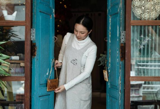 Woman opening store door.